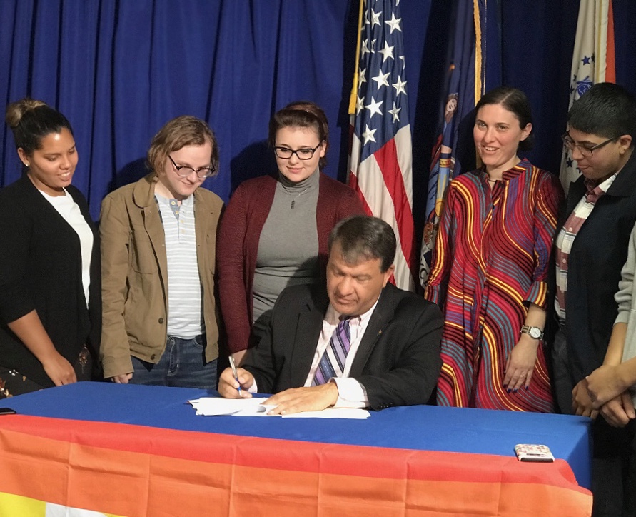 Westchester County Executive George Latimer, joined by members of  the Pace community, signing a bill to ban conversion therapy.