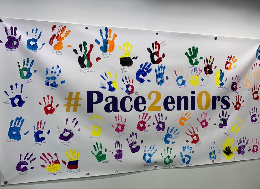 The 2020 banner displays colorful handprints of various seniors. The banner could be found in the entrance of Kessel.  