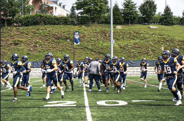 Pace Football rushes on field out of the locker room at the end of the halftime break 