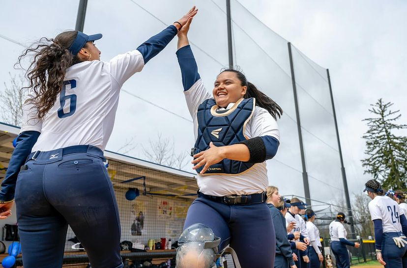 Outfielder Layla Michelson high-fives catcher Carolina Iturriga during a home game(paceathletics/IG)