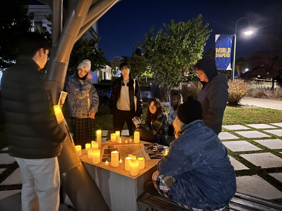 Fans on the Pleasantville Campus gather around a candlelight vigil at the Solar Tree on Thursday night (Photo/Lilah McCormack)